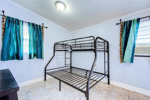 tiled bedroom featuring multiple windows