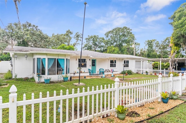 view of front of property with a sunroom and a front lawn