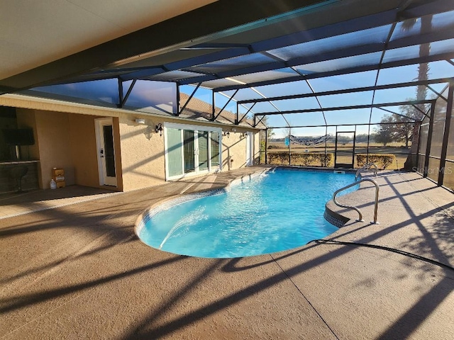 view of pool featuring a lanai and a patio