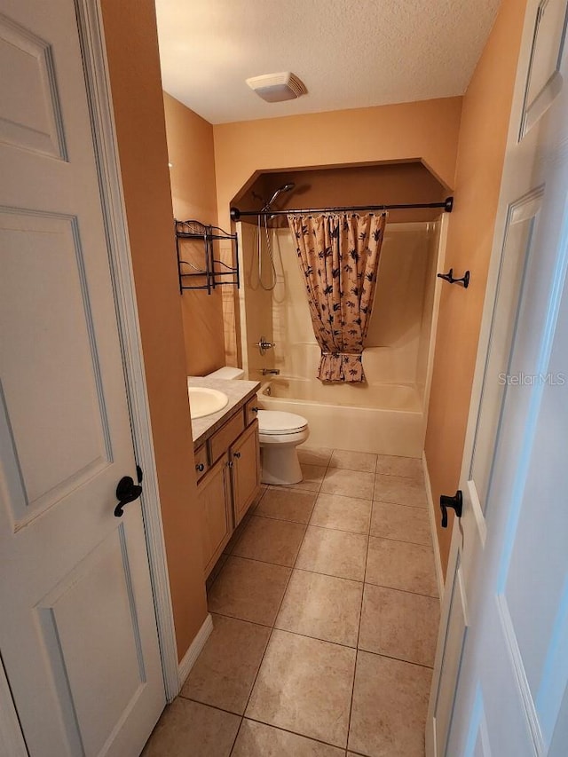 full bathroom with shower / tub combo, vanity, a textured ceiling, tile patterned flooring, and toilet