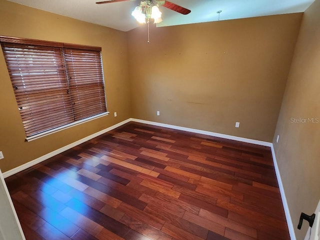 empty room with ceiling fan and dark wood-type flooring