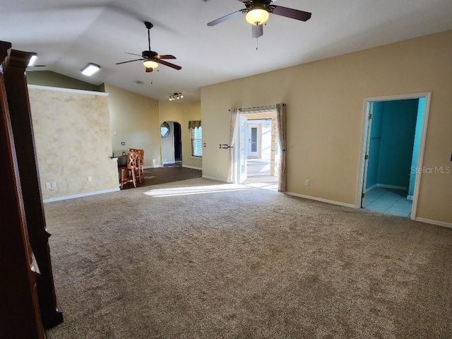 carpeted spare room featuring ceiling fan and vaulted ceiling