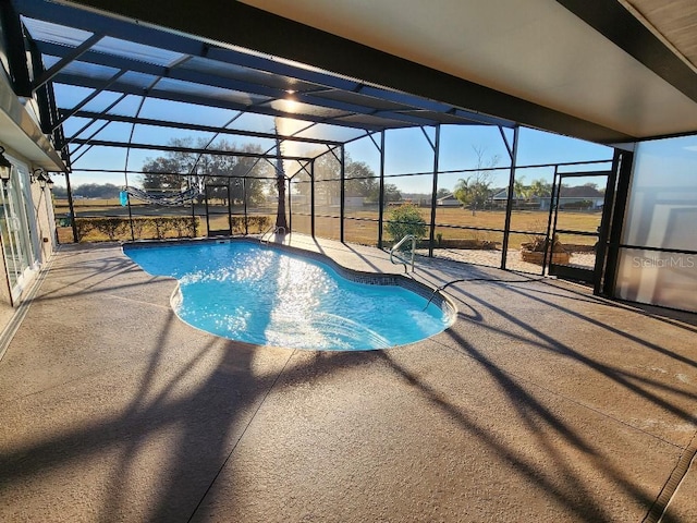 view of swimming pool featuring a lanai and a patio area