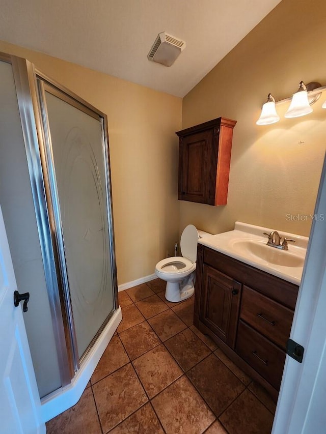 bathroom with vanity, toilet, and a shower with door