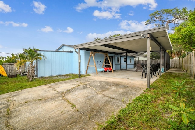 exterior space with a carport and a yard