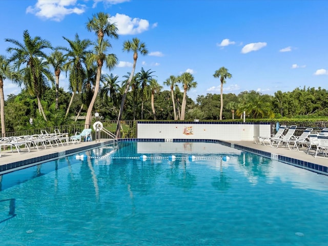 pool with fence and a patio