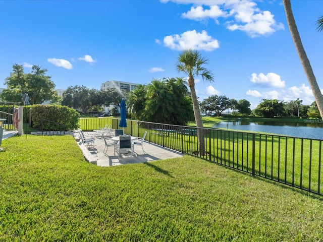 view of home's community featuring a patio area, fence, and a lawn