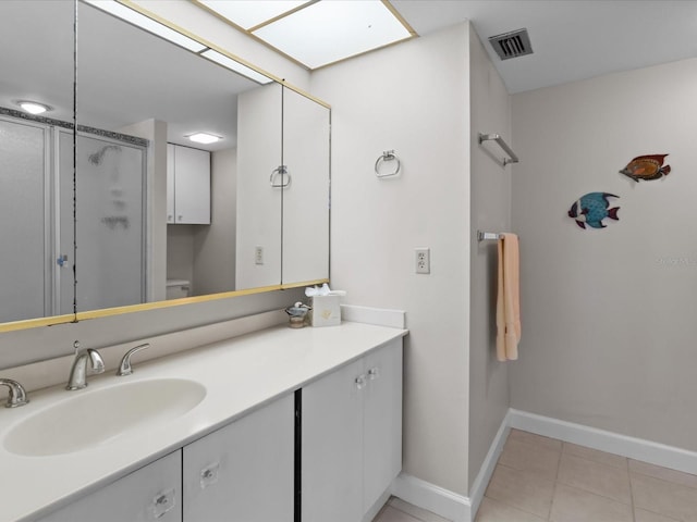 full bathroom featuring baseboards, visible vents, tile patterned flooring, vanity, and a shower stall