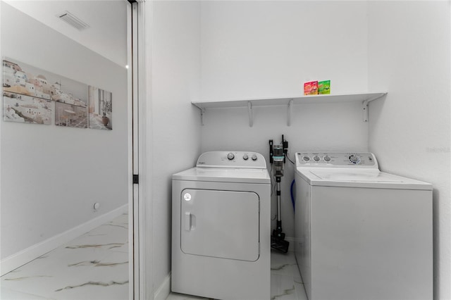 washroom with washer and dryer