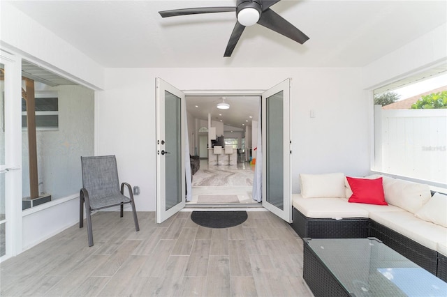 living room featuring ceiling fan and light wood-type flooring