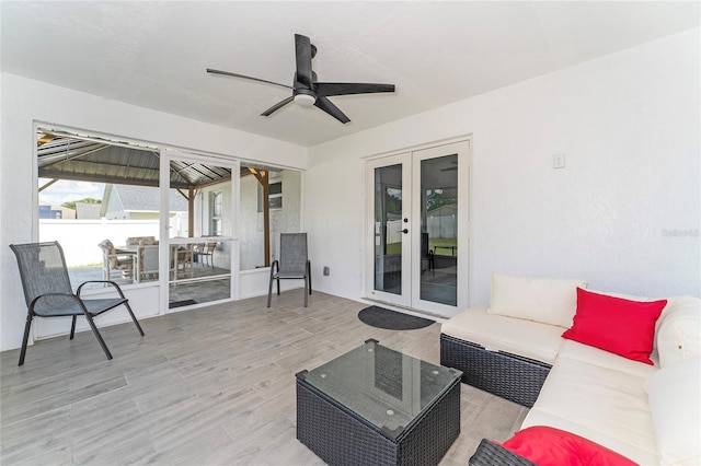 interior space with wood-type flooring, ceiling fan, and french doors