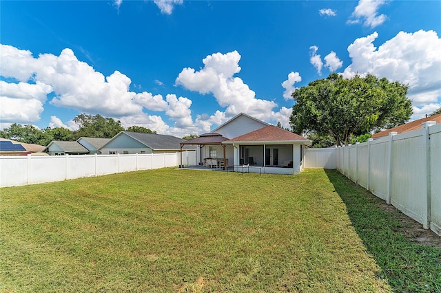 back of house featuring a lawn and a patio area