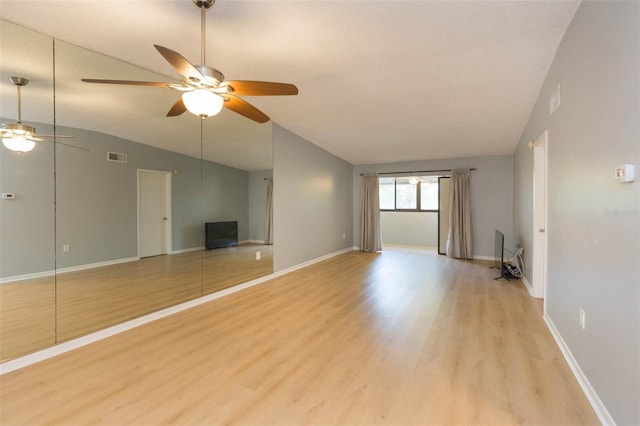 unfurnished living room with lofted ceiling, ceiling fan, and light hardwood / wood-style flooring