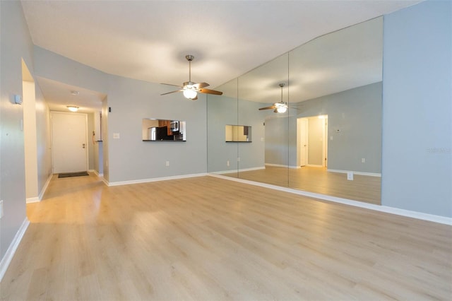 unfurnished living room with light wood-type flooring and ceiling fan