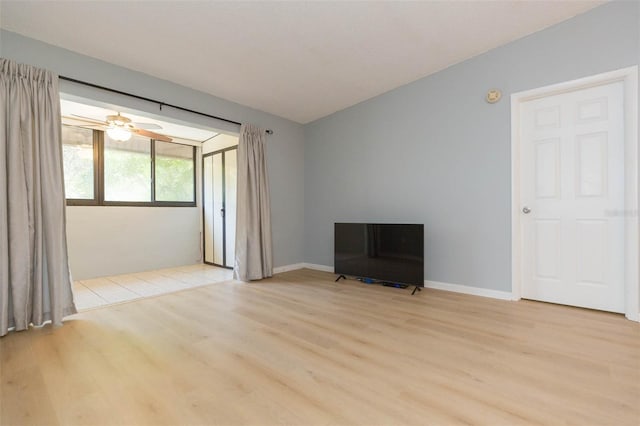 empty room with ceiling fan and light hardwood / wood-style flooring