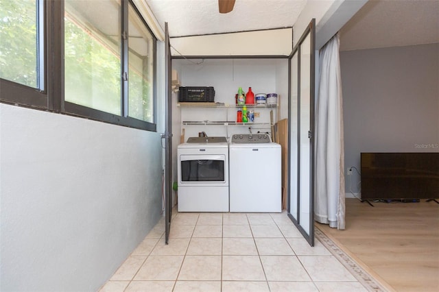 clothes washing area with ceiling fan, a textured ceiling, light tile patterned flooring, and washer and clothes dryer