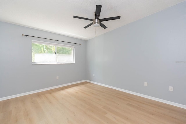 empty room with light wood-type flooring, ceiling fan, and a textured ceiling