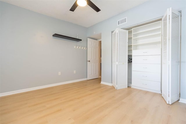 unfurnished bedroom featuring a ceiling fan, light wood-style flooring, baseboards, and visible vents