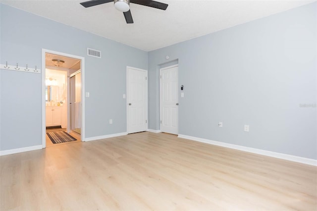 spare room with baseboards, visible vents, light wood finished floors, and ceiling fan