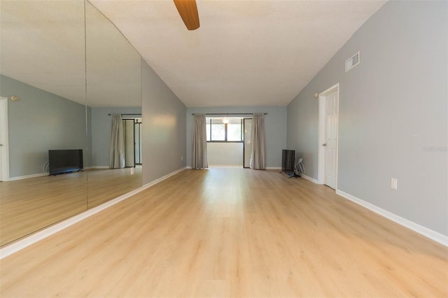 unfurnished living room with a ceiling fan, visible vents, light wood finished floors, and baseboards