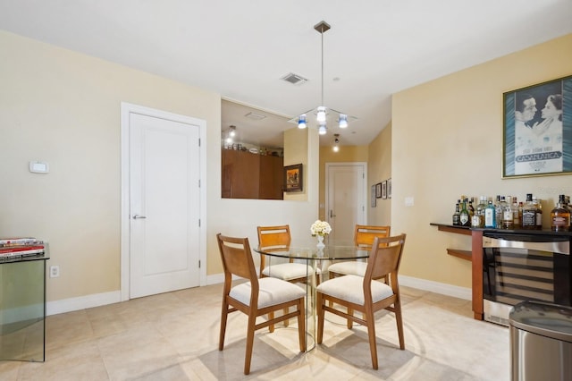 dining area with bar area and wine cooler