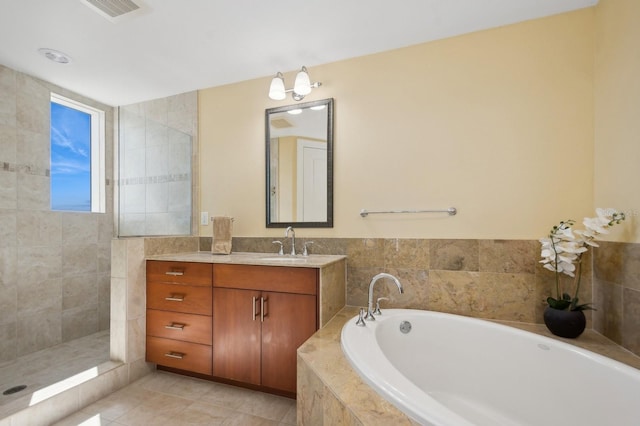 bathroom with independent shower and bath, vanity, and tile patterned floors