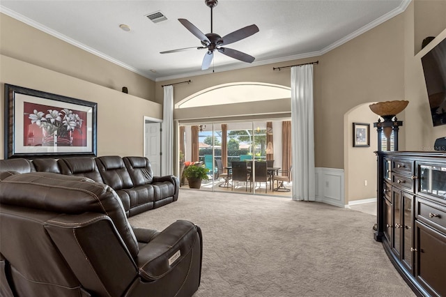 living room with light carpet, ceiling fan, and ornamental molding