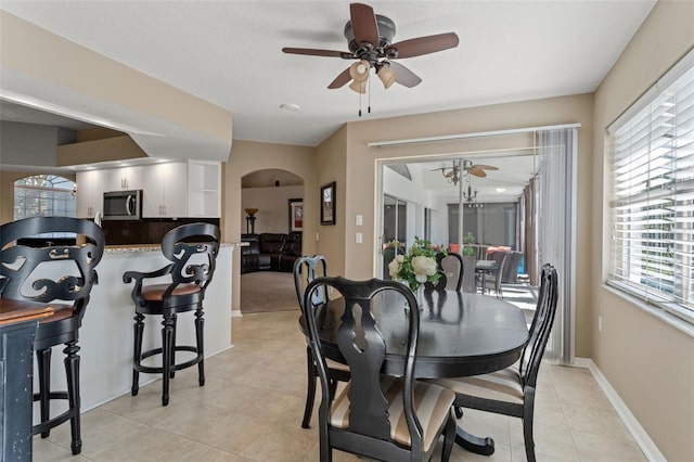 dining area with ceiling fan and light tile patterned floors