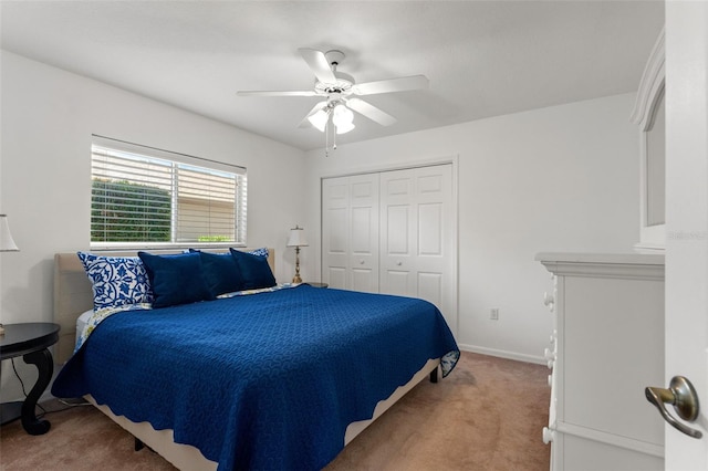 carpeted bedroom featuring ceiling fan and a closet