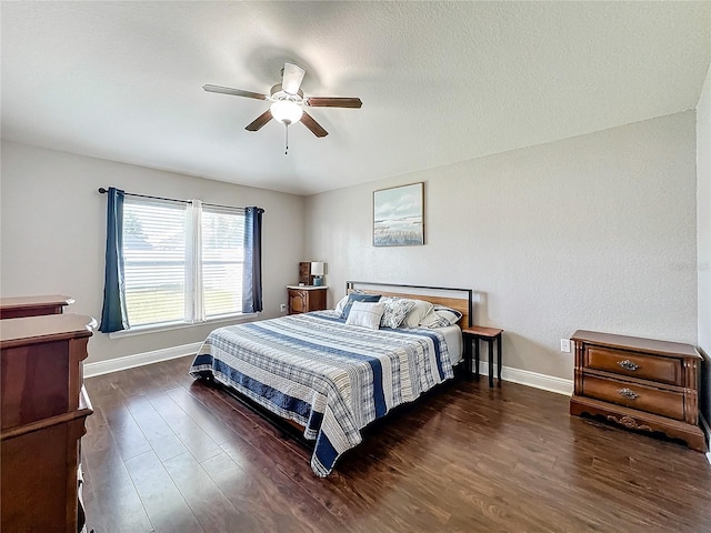 bedroom with ceiling fan and dark wood-type flooring