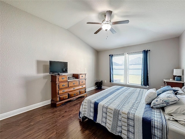 bedroom featuring ceiling fan, dark wood-type flooring, and lofted ceiling