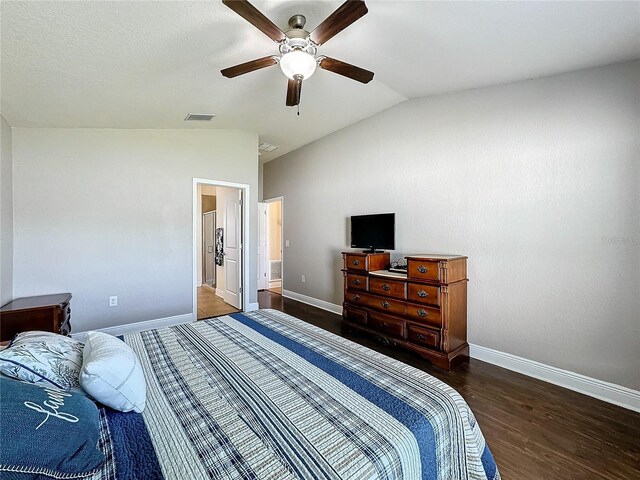 bedroom with vaulted ceiling, ceiling fan, and dark wood-type flooring