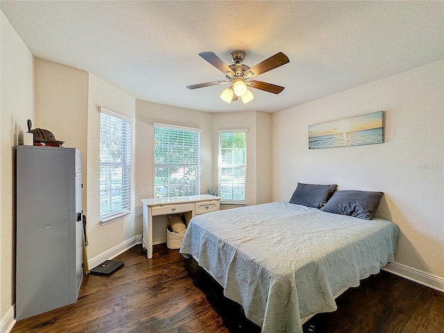 bedroom featuring ceiling fan and dark hardwood / wood-style floors