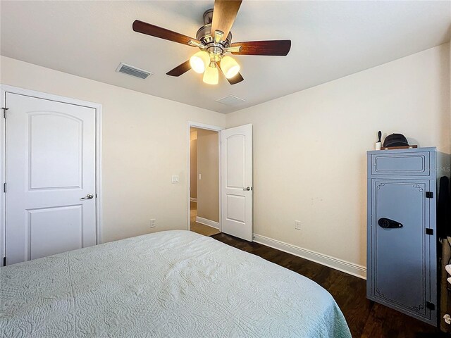 bedroom with ceiling fan and dark wood-type flooring