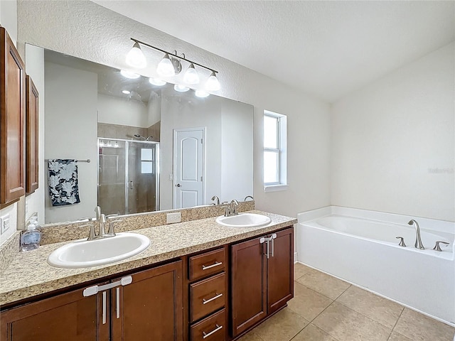 bathroom featuring tile patterned flooring, a textured ceiling, vanity, and independent shower and bath