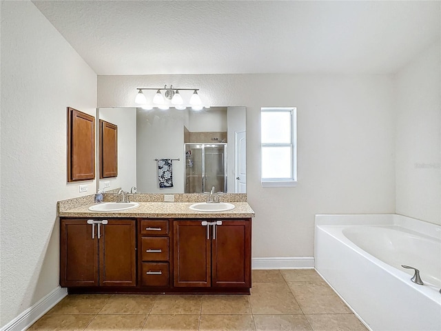 bathroom featuring tile patterned flooring, vanity, and plus walk in shower