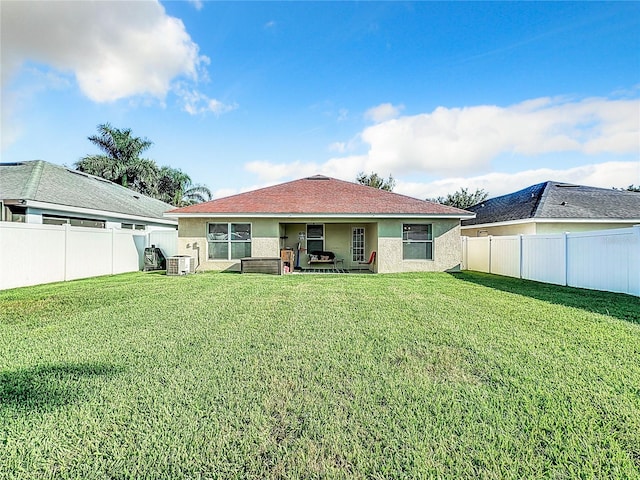 rear view of house with an outdoor living space and a yard