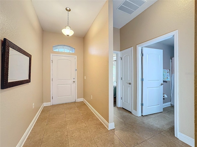 foyer entrance with light tile patterned floors