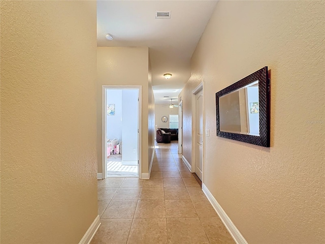 hall with light tile patterned flooring