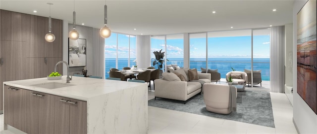 living room with sink, a water view, and floor to ceiling windows