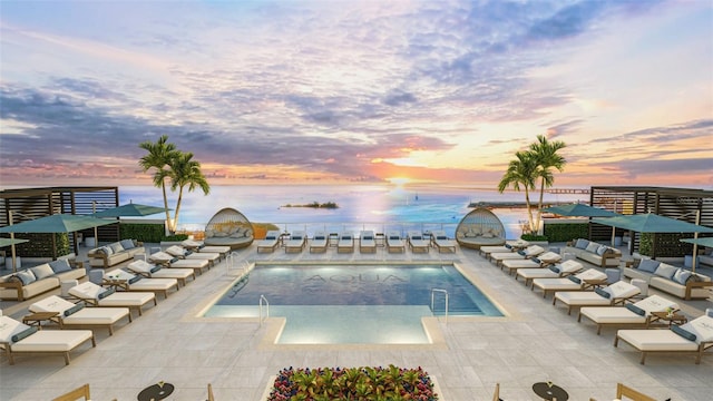 pool at dusk with a patio