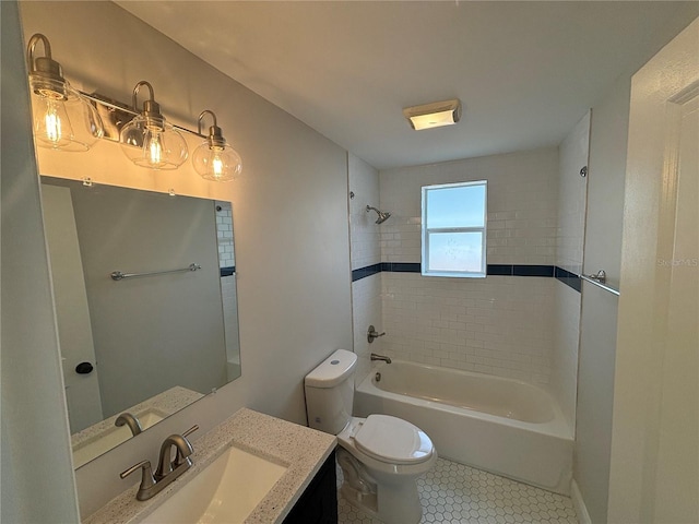 full bathroom with tile patterned floors, tiled shower / bath combo, vanity, and toilet