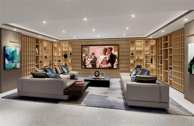 cinema room featuring built in features and a tray ceiling