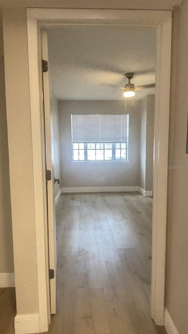 unfurnished room with ceiling fan and hardwood / wood-style floors