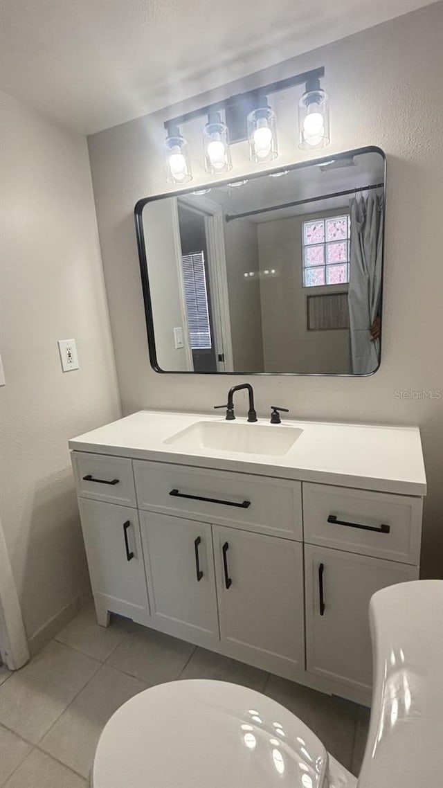 bathroom featuring vanity, toilet, and tile patterned floors