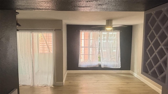 3002 W Cleveland St Unit E1, Tampa, FL 33609 - unfurnished dining area featuring baseboards, wood finished floors, and a ceiling fan