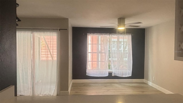 interior space featuring wood-type flooring and ceiling fan