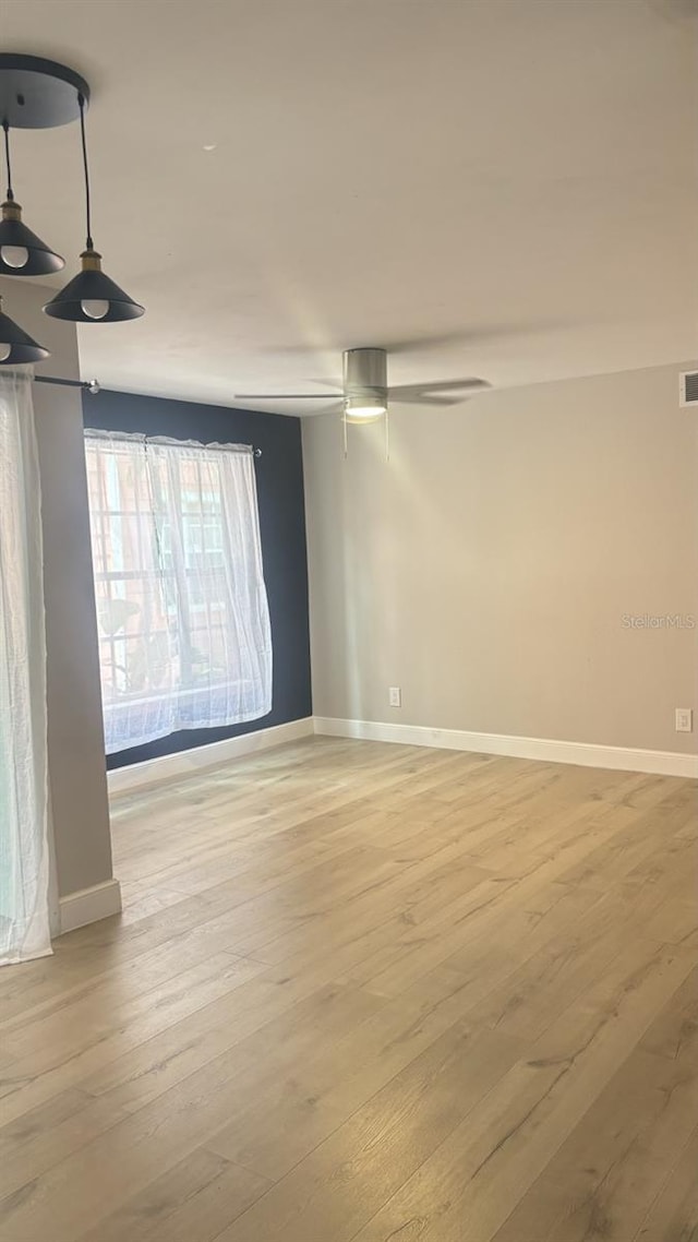 spare room with light hardwood / wood-style floors and ceiling fan