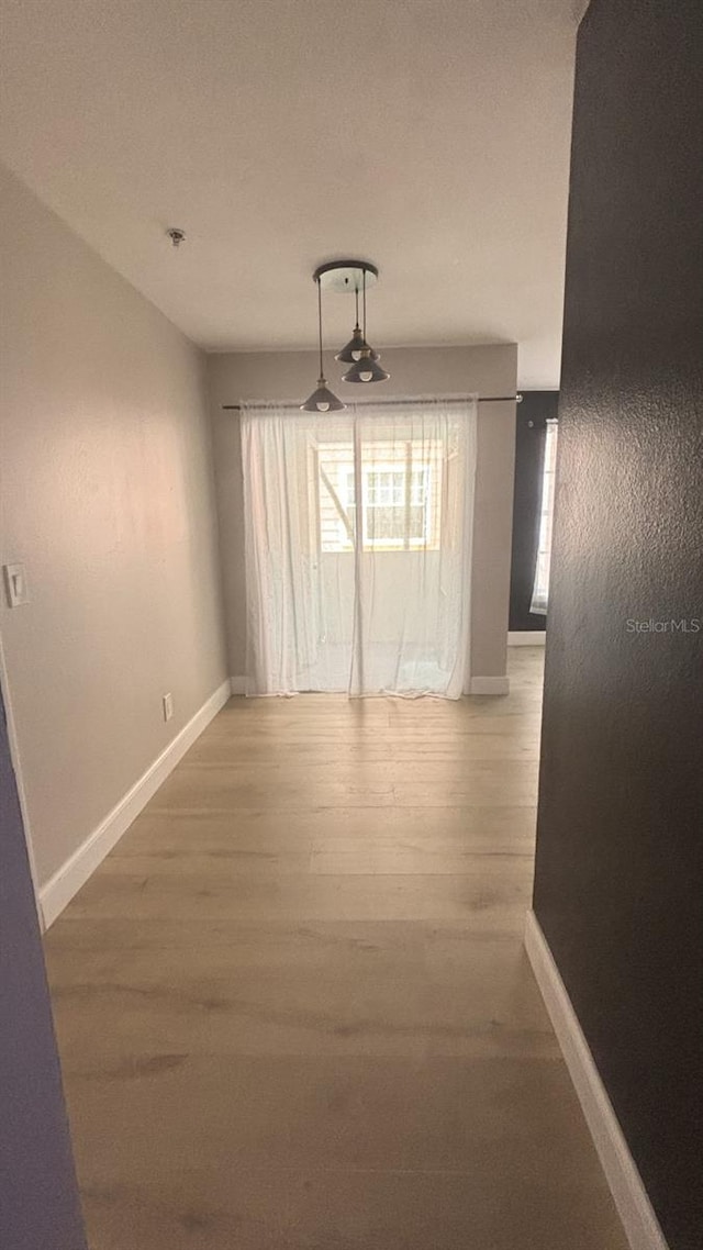 unfurnished dining area featuring hardwood / wood-style floors