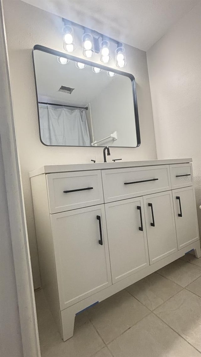 bathroom with vanity and tile patterned floors